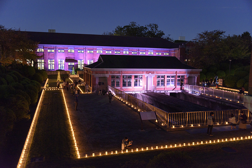 Lit candles surround the former Mikawashima Sewage Disposal Plant Pumping Station