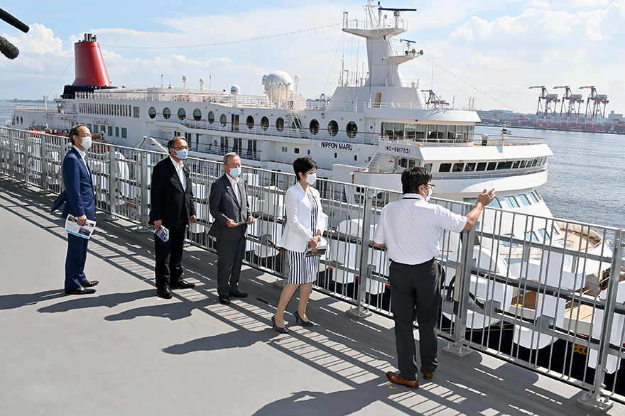 Image of Governor Koike by a ship hearing about Tokyo Port