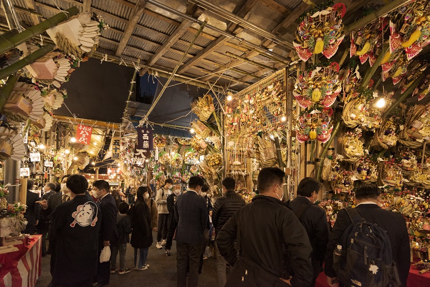 Visitors browsing through decorative rakes at the market