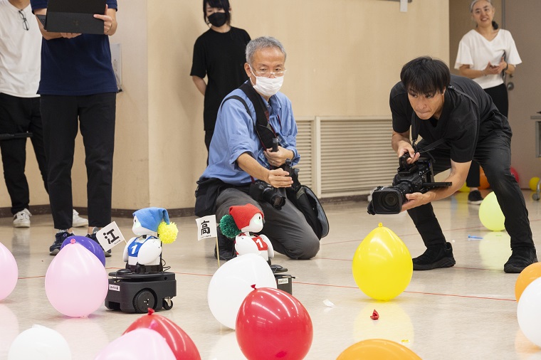Photo 1: Avatar robots competing in balloon popping
