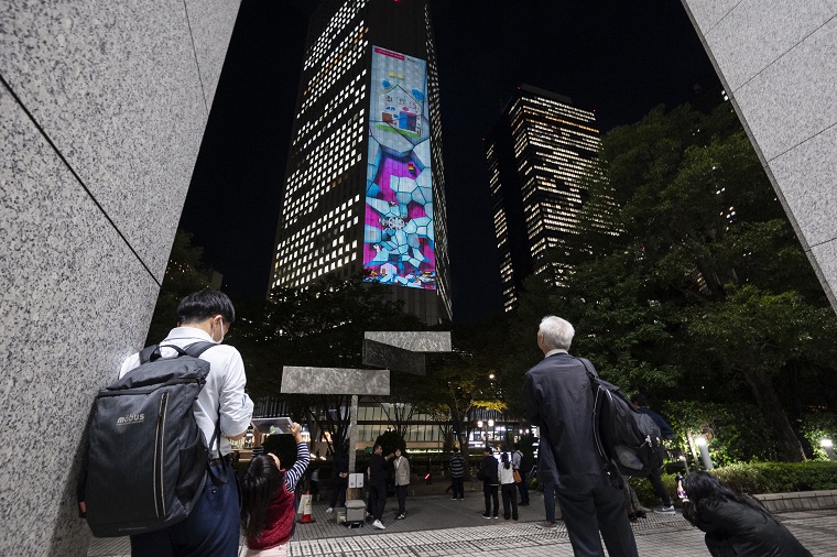 Photo: People looking up at projection mapping