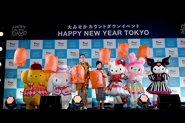 Photo: Performers and characters holding orange lanterns